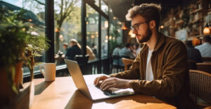 Person using a laptop on public Wi-Fi in a café environment
